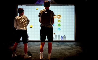 Boys playing the interactive game Multiball